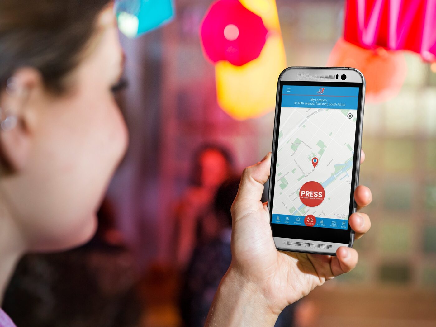 Young woman out at night with the Premium Help app open